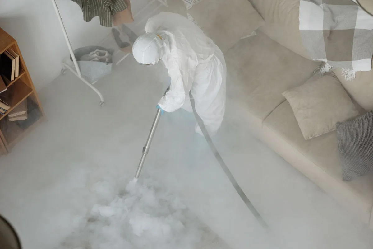 Biohazard cleanup technician in protective equipment, Northwoods, MO